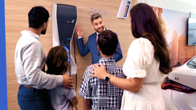 Family looking at BMW iX electric charger
